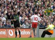 25 September 2005; Tyrone captain Brian Dooher is shown a yelow card by referee Michael Monahan. Bank of Ireland All-Ireland Senior Football Championship Final, Kerry v Tyrone, Croke Park, Dublin. Picture credit; Brendan Moran / SPORTSFILE *** Local Caption *** Any photograph taken by SPORTSFILE during, or in connection with, the 2005 Bank of Ireland All-Ireland Senior Football Final which displays GAA logos or contains an image or part of an image of any GAA intellectual property, or, which contains images of a GAA player/players in their playing uniforms, may only be used for editorial and non-advertising purposes.  Use of photographs for advertising, as posters or for purchase separately is strictly prohibited unless prior written approval has been obtained from the Gaelic Athletic Association.