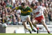 25 September 2005; Michael McCarthy, Kerry, holds off the challenge of Stephen O'Neill, Tyrone. Bank of Ireland All-Ireland Senior Football Championship Final, Kerry v Tyrone, Croke Park, Dublin. Picture credit; Brendan Moran / SPORTSFILE *** Local Caption *** Any photograph taken by SPORTSFILE during, or in connection with, the 2005 Bank of Ireland All-Ireland Senior Football Final which displays GAA logos or contains an image or part of an image of any GAA intellectual property, or, which contains images of a GAA player/players in their playing uniforms, may only be used for editorial and non-advertising purposes.  Use of photographs for advertising, as posters or for purchase separately is strictly prohibited unless prior written approval has been obtained from the Gaelic Athletic Association.