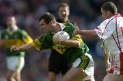 25 September 2005; Michael McCarthy, Kerry, is tackled by Stephen O'Neill, Tyrone. Bank of Ireland All-Ireland Senior Football Championship Final, Kerry v Tyrone, Croke Park, Dublin. Picture credit; Brendan Moran / SPORTSFILE *** Local Caption *** Any photograph taken by SPORTSFILE during, or in connection with, the 2005 Bank of Ireland All-Ireland Senior Football Final which displays GAA logos or contains an image or part of an image of any GAA intellectual property, or, which contains images of a GAA player/players in their playing uniforms, may only be used for editorial and non-advertising purposes.  Use of photographs for advertising, as posters or for purchase separately is strictly prohibited unless prior written approval has been obtained from the Gaelic Athletic Association.