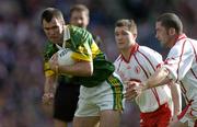 25 September 2005; Michael McCarthy, Kerry, in action against Enda McGinley and Stephen O'Neill, right, Tyrone. Bank of Ireland All-Ireland Senior Football Championship Final, Kerry v Tyrone, Croke Park, Dublin. Picture credit; Brendan Moran / SPORTSFILE *** Local Caption *** Any photograph taken by SPORTSFILE during, or in connection with, the 2005 Bank of Ireland All-Ireland Senior Football Final which displays GAA logos or contains an image or part of an image of any GAA intellectual property, or, which contains images of a GAA player/players in their playing uniforms, may only be used for editorial and non-advertising purposes.  Use of photographs for advertising, as posters or for purchase separately is strictly prohibited unless prior written approval has been obtained from the Gaelic Athletic Association.