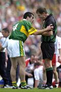 25 September 2005; Tom O'Sullivan, Kerry, is spoken to by referee Michael Monahan before receiving a yellow card. Bank of Ireland All-Ireland Senior Football Championship Final, Kerry v Tyrone, Croke Park, Dublin. Picture credit; Brendan Moran / SPORTSFILE *** Local Caption *** Any photograph taken by SPORTSFILE during, or in connection with, the 2005 Bank of Ireland All-Ireland Senior Football Final which displays GAA logos or contains an image or part of an image of any GAA intellectual property, or, which contains images of a GAA player/players in their playing uniforms, may only be used for editorial and non-advertising purposes.  Use of photographs for advertising, as posters or for purchase separately is strictly prohibited unless prior written approval has been obtained from the Gaelic Athletic Association.