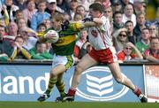 25 September 2005; Darren O'Sullivan, Kerry, in action against Colin Holmes, Tyrone. Bank of Ireland All-Ireland Senior Football Championship Final, Kerry v Tyrone, Croke Park, Dublin. Picture credit; Brendan Moran / SPORTSFILE *** Local Caption *** Any photograph taken by SPORTSFILE during, or in connection with, the 2005 Bank of Ireland All-Ireland Senior Football Final which displays GAA logos or contains an image or part of an image of any GAA intellectual property, or, which contains images of a GAA player/players in their playing uniforms, may only be used for editorial and non-advertising purposes.  Use of photographs for advertising, as posters or for purchase separately is strictly prohibited unless prior written approval has been obtained from the Gaelic Athletic Association.