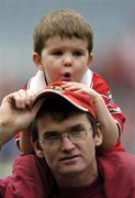 2 October 2005; Cork fan Cian Casey, age 3, grandnephew of Cork player Denis O'Riordan, who won an All-Ireland medal in 1966, sits on his father Conor's shoulders after the match. TG4 Ladies All-Ireland Senior Football Championship Final, Galway v Cork, Croke Park, Dublin. Picture credit: Brian Lawless / SPORTSFILE