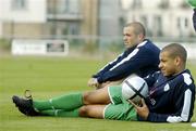 5 October 2005; Republic of Ireland's Steven Reid and Stephen Carr, behind, watch the action during squad training. Malahide FC, Malahide, Dublin. Picture credit: Ciara Lyster / SPORTSFILE