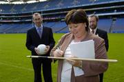 5 October 2005; Tanaiste and Minister for Health and Children, Mary Harney T.D., signs a hurley, as Newly appointed National Co-ordinator of the Alcohol and Substance Abuse Initiative to tackle major Societal Issues, Brendan Murphy, left, and Sean Kelly, President of the GAA, look on at the launch of a new joint initiative by the GAA and the Department of Health and Children aimed at reducing alcohol-related harm and changing attitudes towards alcohol consumption in Ireland. Croke Park, Dublin. Picture credit: Damien Eagers / SPORTSFILE