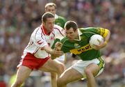 25 September 2005; Michael McCarthy, Kerry, in action against Stephen O'Neill, Tyrone. Bank of Ireland All-Ireland Senior Football Championship Final, Kerry v Tyrone, Croke Park, Dublin. Picture credit; Ray McManus / SPORTSFILE *** Local Caption *** Any photograph taken by SPORTSFILE during, or in connection with, the 2005 Bank of Ireland All-Ireland Senior Football Final which displays GAA logos or contains an image or part of an image of any GAA intellectual property, or, which contains images of a GAA player/players in their playing uniforms, may only be used for editorial and non-advertising purposes.  Use of photographs for advertising, as posters or for purchase separately is strictly prohibited unless prior written approval has been obtained from the Gaelic Athletic Association.