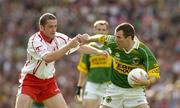 25 September 2005; Michael McCarthy, Kerry, in action against Stephen O'Neill, Tyrone. Bank of Ireland All-Ireland Senior Football Championship Final, Kerry v Tyrone, Croke Park, Dublin. Picture credit; Ray McManus / SPORTSFILE *** Local Caption *** Any photograph taken by SPORTSFILE during, or in connection with, the 2005 Bank of Ireland All-Ireland Senior Football Final which displays GAA logos or contains an image or part of an image of any GAA intellectual property, or, which contains images of a GAA player/players in their playing uniforms, may only be used for editorial and non-advertising purposes.  Use of photographs for advertising, as posters or for purchase separately is strictly prohibited unless prior written approval has been obtained from the Gaelic Athletic Association.