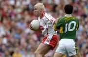 25 September 2005; Owen Mulligan, Tyrone, in action against Paul Galvin, Kerry. Bank of Ireland All-Ireland Senior Football Championship Final, Kerry v Tyrone, Croke Park, Dublin. Picture credit; Ray McManus / SPORTSFILE *** Local Caption *** Any photograph taken by SPORTSFILE during, or in connection with, the 2005 Bank of Ireland All-Ireland Senior Football Final which displays GAA logos or contains an image or part of an image of any GAA intellectual property, or, which contains images of a GAA player/players in their playing uniforms, may only be used for editorial and non-advertising purposes.  Use of photographs for advertising, as posters or for purchase separately is strictly prohibited unless prior written approval has been obtained from the Gaelic Athletic Association.