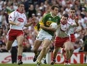 25 September 2005; Eoin Brosnan, Kerry, in action against Conor Gormley, centre, Ryan McMenamin, right, and Michael McGee, left, Tyrone. Bank of Ireland All-Ireland Senior Football Championship Final, Kerry v Tyrone, Croke Park, Dublin. Picture credit; Ray McManus / SPORTSFILE *** Local Caption *** Any photograph taken by SPORTSFILE during, or in connection with, the 2005 Bank of Ireland All-Ireland Senior Football Final which displays GAA logos or contains an image or part of an image of any GAA intellectual property, or, which contains images of a GAA player/players in their playing uniforms, may only be used for editorial and non-advertising purposes.  Use of photographs for advertising, as posters or for purchase separately is strictly prohibited unless prior written approval has been obtained from the Gaelic Athletic Association.