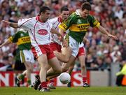 25 September 2005; Eoin Brosnan, Kerry, in action against Michael McGee, Tyrone. Bank of Ireland All-Ireland Senior Football Championship Final, Kerry v Tyrone, Croke Park, Dublin. Picture credit; Ray McManus / SPORTSFILE *** Local Caption *** Any photograph taken by SPORTSFILE during, or in connection with, the 2005 Bank of Ireland All-Ireland Senior Football Final which displays GAA logos or contains an image or part of an image of any GAA intellectual property, or, which contains images of a GAA player/players in their playing uniforms, may only be used for editorial and non-advertising purposes.  Use of photographs for advertising, as posters or for purchase separately is strictly prohibited unless prior written approval has been obtained from the Gaelic Athletic Association.