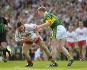 25 September 2005; Michael McGee, Tyrone, in action against Mike Frank Russell, Kerry. Bank of Ireland All-Ireland Senior Football Championship Final, Kerry v Tyrone, Croke Park, Dublin. Picture credit; Ray McManus / SPORTSFILE *** Local Caption *** Any photograph taken by SPORTSFILE during, or in connection with, the 2005 Bank of Ireland All-Ireland Senior Football Final which displays GAA logos or contains an image or part of an image of any GAA intellectual property, or, which contains images of a GAA player/players in their playing uniforms, may only be used for editorial and non-advertising purposes.  Use of photographs for advertising, as posters or for purchase separately is strictly prohibited unless prior written approval has been obtained from the Gaelic Athletic Association.