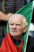 25 September 2005; A Mayo fan watches the game. ESB All-Ireland Minor Football Championship Final, Mayo v Down, Croke Park, Dublin. Picture credit; Ray McManus / SPORTSFILE *** Local Caption *** Any photograph taken by SPORTSFILE during, or in connection with, the 2005 ESB All-Ireland Minor Football Final which displays GAA logos or contains an image or part of an image of any GAA intellectual property, or, which contains images of a GAA player/players in their playing uniforms, may only be used for editorial and non-advertising purposes.  Use of photographs for advertising, as posters or for purchase separately is strictly prohibited unless prior written approval has been obtained from the Gaelic Athletic Association.
