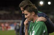 12 October 2005; A dejected Matt Holland, Republic of Ireland, leaves the field after the game accompanied by team security officer Derek McGuinness. FIFA 2006 World Cup Qualifier, Group 4, Republic of Ireland v Switzerland, Lansdowne Road, Dublin. Picture credit: Brendan Moran / SPORTSFILE