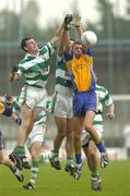 16 October 2005; Mark Cooper, Na Fianna, in action against Ciaran Cross, left, and Feargal Dardis, Round Towers. Dublin County Juinor Football Final, Na Fianna v Round Towers, Parnell Park, Dublin. Picture credit: Brian Lawless / SPORTSFILE