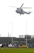 16 October 2005; A British army helicopter takes off as the teams warm up before the start of the game. Armagh County Senior Football Final, Crossmaglen Rangers v Dromintee, Crossmaglen, Armagh. Picture credit: David Maher / SPORTSFILE