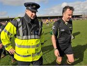 23 March 2014; Referee Diarmuid Kirwan is escorted off the pitch after the game. Allianz Hurling League Division 1A Round 5, Clare v Galway, Cusack Park, Ennis, Co. Clare. Picture credit: Ray Ryan / SPORTSFILE