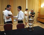 20 October 2005; The Cormac McAnallen Cup rests on a table as Padraic Joyce and Pete McGrath are interviewed after the final Press Conference advance of the Fosters International Rules game between Australia and Ireland, Sheraton Perth Hotel, Adelaide Terrace, Perth, Western Australia. Picture credit; Ray McManus / SPORTSFILE
