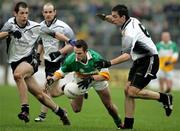 23 October 2005; Mark Donnelly, Carrickmore, under pressure from the Mc Mahon brothers Patrick and Joe, Omagh. Tyrone Senior Football Championship Final, Omagh v Carrickmore. Omagh, Co. Tyrone. Picture credit: Oliver McVeigh / SPORTSFILE