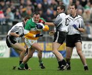 23 October 2005; Ronan McGarrity, Carrickmore, tries to break free from Omagh's Michael O Neill and Patrick McMahon, Omagh. Tyrone Senior Football Championship Final, Omagh v Carrickmore. Omagh, Co. Tyrone. Picture credit: Oliver McVeigh / SPORTSFILE