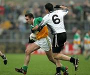 23 October 2005; Mark Donnelly, Carrickmore, in action against Justin McMahon, Omagh. Tyrone Senior Football Championship Final, Omagh v Carrickmore. Omagh, Co. Tyrone. Picture credit: Oliver McVeigh / SPORTSFILE