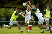 24 October 2005; Philip Jordan, left, and Mattie Forde, right, attempt to block Ronan Clarke during the Ireland team training in advance of the 2nd Fosters International Rules game between Australia and Ireland, Sorrento Oval, Sorrento, Mornington Peninsula, Melbourne, Australia. Picture credit; Ray McManus / SPORTSFILE