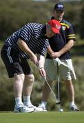 25 October 2005; Larry Tompkins, watched by captain Padraic Joyce, during a round of golf at the Portsea Golf Club, Sorrento, Mornington Peninsula, Melbourne, Victoria, Australia. Picture credit; Ray McManus / SPORTSFILE
