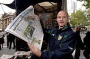 26 October 2005; Ireland's Tom Kelly shows the 'Herald Sun', in which Russell Robertson says sorry for the tackle in the first game, beside a newstand on Collins Street, Melbourne, Victoria, Australia. Picture credit; Ray McManus / SPORTSFILE