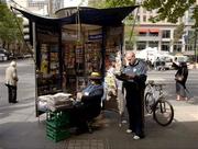 26 October 2005; Ireland's Tom Kelly reads the 'Herald Sun', in which Russell Robertson says sorry for the tackle in the first game, beside a newstand on Collins Street, Melbourne, Victoria, Australia. Picture credit; Ray McManus / SPORTSFILE