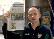 26 October 2005; Ireland's Tom Kelly shows the 'Herald Sun', in which Russell Robertson says sorry for the tackle in the first game, beside a newstand on Collins Street, Melbourne, Victoria, Australia. Picture credit; Ray McManus / SPORTSFILE