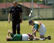 18 October 2005; Ross Munnelly, Laois, is attended to by Eoghan O'Neill, right, and Dr Con Murphy during a training session, at the Mandurah Football and Sports Club, in advance of the Fosters International Rules game between Australia and Ireland. Mandurah Football and Sports Club, Rushton Park, Mandurah, Perth, Western Australia. Picture credit; Ray McManus / SPORTSFILE