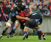 29 October 2005; Anthony Foley, Munster, is tackled by Remy Vigneaux and Puricelli, Castres Olympique. Heineken Cup 2005-2006, Pool 1, Munster v Castres Olympique, Thomond Park, Limerick. Picture credit; Kieran Clancy / SPORTSFILE