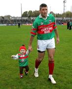 30 October 2005; Johnny Daly, Kilmurry-Ibrickane, with his daughter Sophie, during the parade before the game. Clare County Senior Football Championship Final, Kilmurry-Ibrickane v St. Senan's, Cusack Park, Ennis, Co. Clare. Picture credit: Kieran Clancy / SPORTSFILE