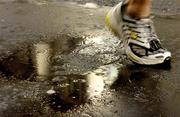 31 October 2005; An athlete splashes through a puddle during the 2005 adidas Dublin City Marathon. Picture credit: Pat Murphy / SPORTSFILE