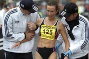 31 October 2005; Ireland's Pauline Curley is helped by race marshels after finishing the 2005 adidas Dublin City Marathon. Picture credit: Brendan Moran / SPORTSFILE