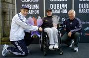 31 October 2005; Women's Wheelchair race winner Patrice Dockery is presented with her trpohy by Race Director Jim Aughney, left, and Robin Money, Head of Sports Marketing, adidas Area North, during the 2005 adidas Dublin City Marathon. Picture credit: Brendan Moran / SPORTSFILE