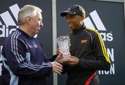 31 October 2005; 2nd placed Neo Molema of South Africa, is presented with his trophy by Robin Money, Head of Sports Marketing, adidas Area North, during the 2005 adidas Dublin City Marathon. Picture credit: Brendan Moran / SPORTSFILE