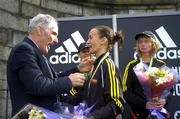 31 October 2005; Pauline Curley is presented with her medal as National Women's Marathon Champion by Michael Heery, President of the AAI, after finishing as first Irish woman home, during the 2005 adidas Dublin City Marathon. Picture credit: Brendan Moran / SPORTSFILE
