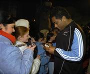 9 November 2005; Neema Tialata, member of the New Zealand All Blacks team, looks at a fans camera during a visit to the birthplace of Dave Gallaher as part of centenary celebrations for the Originals tour. Players and New Zealand Rugby Union officials travelled to the village of Ramelton in County Donegal where the Originals' captain was born. Ramelton, Co. Donegal. Picture credit: Pat Murphy / SPORTSFILE