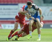 30 March 2014; Tiernan O'Halloran, Connacht, is tackled by Olly Barkley, left, and Ken Owens, Scarlets. Celtic League 2013/14, Round 18, Scarlets v Connacht, Parc Y Scarlets, Llanelli, Wales. Picture credit: Ian Cook / SPORTSFILE