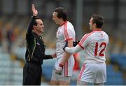 30 March 2014; Tyrone's Colm Cavanagh, centre, and Mark Donnelly speak to referee David Colrick. Allianz Football League Division 1, Round 6, Cork v Tyrone, Pairc Ui Rinn, Cork. Picture credit: Ramsey Cardy / SPORTSFILE