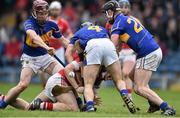 30 March 2014; Conor Lehane, Cork, is tackled by Tipperary players, from left, Paddy Stapleton, Conor O'Brien and Thomas Stapleton. Allianz Hurling League Division 1, Quarter-Final, Tipperary v Cork, Semple Stadium, Thurles, Tipperary. Picture credit: David Maher / SPORTSFILE