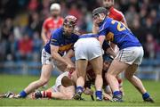 30 March 2014; Conor Lehane, Cork, is tackled by Tipperary players from left, Paddy Stapleton, Conor O'Brien and Thomas Stapleton. Allianz Hurling League Division 1, Quarter-Final, Tipperary v Cork, Semple Stadium, Thurles, Tipperary. Picture credit: David Maher / SPORTSFILE