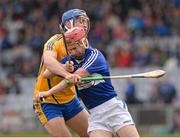 30 March 2014; John A Delaney, Laois, prepares to clear under pressure from Clare's Conor Ryan. Allianz Hurling League Division 1, Quarter-Final, Laois v Clare, O'Moore Park, Portlaoise, Co. Laois. Picture credit: Ray McManus / SPORTSFILE