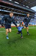 29 March 2014; Dublin's Paul Flynn and Bryan Cullen, right, make their way onto the pitch with match day mascot Éabha Ní Mhaoldúin, four years, and a member of the Round Tower GAA Club / Gaelscoil Chluain Dolcáin. Allianz Football League, Division 1, Round 6, Dublin v Mayo. Croke Park, Dublin. Picture credit: Ray McManus / SPORTSFILE