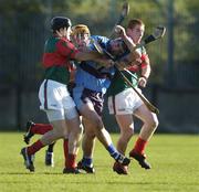 13 November 2005; Stephen Lucey, UCD, in action against Brian Whelahan, left, Niall Claffey, and Barry Whelahan, right, Birr. Leinster Club Senior Hurling Championship Quarter-Final, UCD v Birr, Parnell Park, Dublin. Picture credit: Brian Lawless / SPORTSFILE
