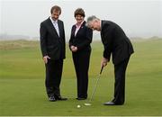 3 April 2014; George O'Grady, Chief Executive of the European Tour, Arlene Foster, MLA, Minister of Enterprise Trade and Investment of the Northern Ireland Executive, and Northern Ireland First Minister Peter Robinson, MLA, sinks a putt on the 18th green after an Irish Open press conference. Royal County Down Golf Course, Newcastle, Co. Down. Picture credit: Oliver McVeigh / SPORTSFILE