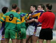 27 November 2005; Johnny Magee, second from left, Kilmacud Crokes, holds his team-mate Ray Cosgrave, after a clash with Shane Sullivan, Rhode, third from left, after which referee Mick Monaghan sent of Ray Cosgrave. Leinster Club Senior Football Championship Semi-Final, Kilmacud Crokes v Rhode, St. Conleth's Park, Newbridge, Co. Kildare. Picture credit: David Maher / SPORTSFILE