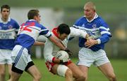 27 November 2005; Roibeard MacGearailt, An Ghaeltacht, in action against Jimmy Larkin and Denis Russell, St. Senans Kilkee. Munster Club Senior Football Championship Semi-Final, St. Senans Kilkee v An Ghaeltacht, Cooraclare, Co. Clare. Picture credit: Kieran Clancy / SPORTSFILE