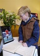 28 November 2005; Craig Curtis, aged 12 from Kells, Co. Meath signing a book of condolence for the late George Best at the offices of the Football Association of Ireland. Merrion Square, Dublin. Picture credit: Damien Eagers / SPORTSFILE