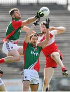 6 April 2014; Seamus O'Shea, left, and Tom Parsons, Mayo, in action against Niall Holly, Derry. Allianz Football League, Division 1, Round 7, Mayo v Derry, Elverys MacHale Park, Castlebar, Co. Mayo. Picture credit: Ray Ryan / SPORTSFILE